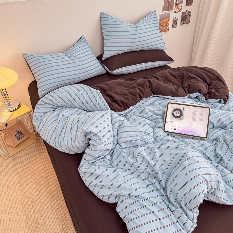 Blue striped bedding set with thin lines on white and a dark brown solid reverse
