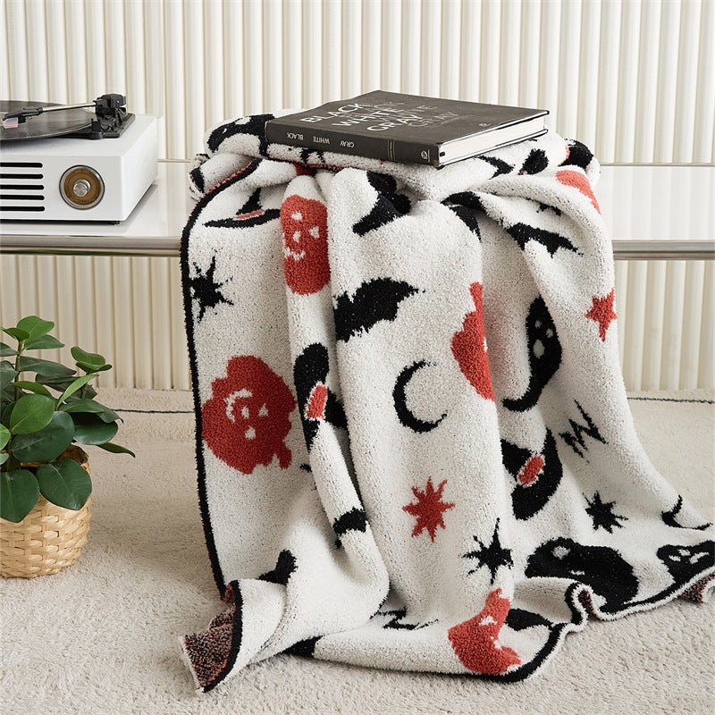 Hollow Halloween Print Fleece Throw Blanket - folded over a stool with speckled reverse - WhisperLinens