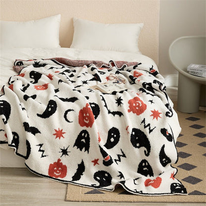 Hollow Halloween Print Fleece Throw Blanket - ghost and pumpkin throw draped over a bed - WhisperLinens
