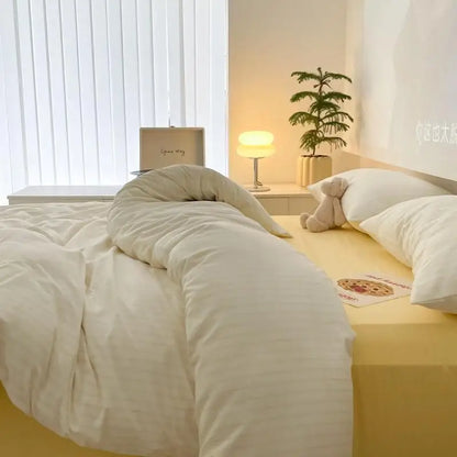 ivory bedding set with yellow stripes on bed