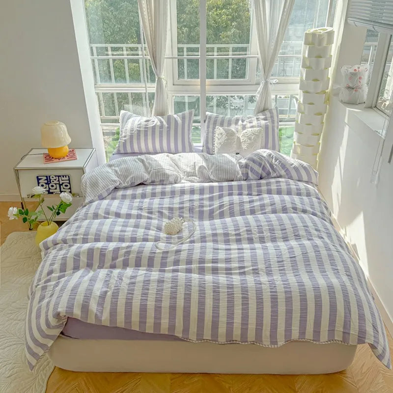 cream bedding set with lilac and plum stripes