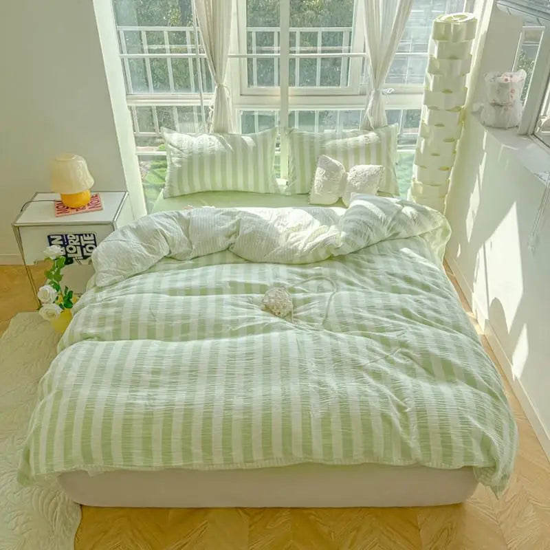 cream bedding set with pastel lime and teal green stripes
