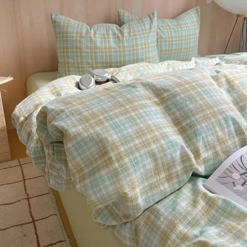 mint and beige plaid cotton bedding set on bed