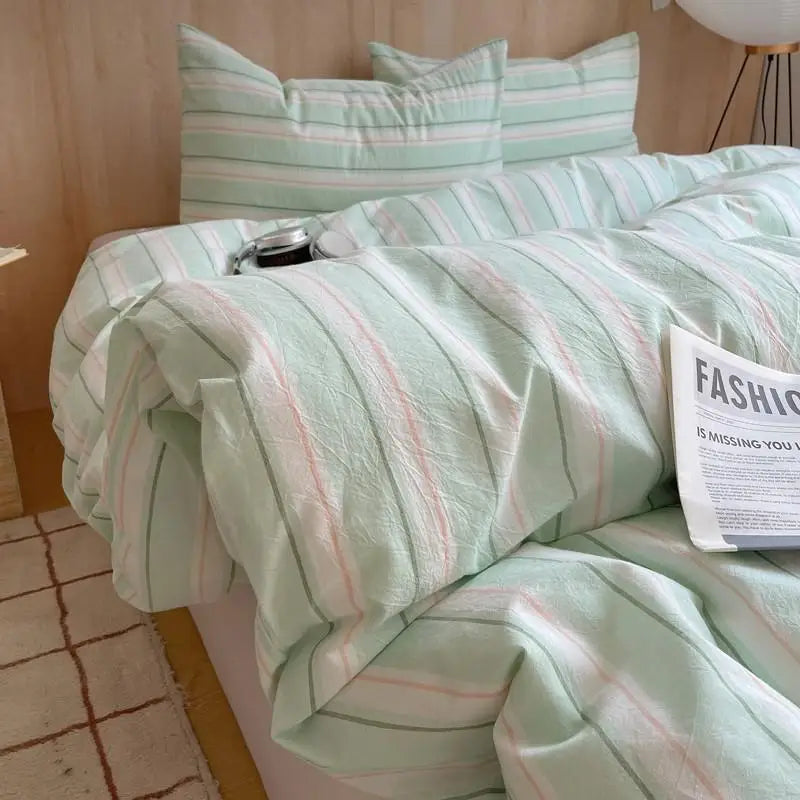 Mint green bedding set with light pink and grey striped pattern for fresh and airy bedroom style