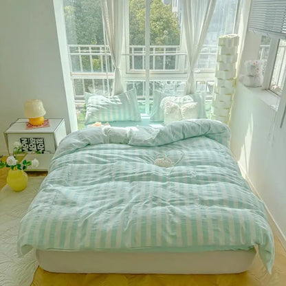 mint and white striped cotton bedding set on bed
