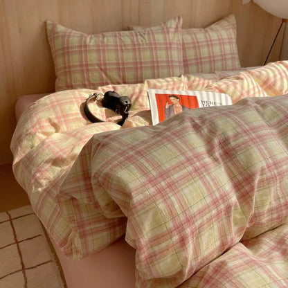 pastel pink and yellow plaid cotton bedding set on bed