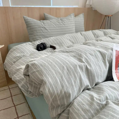 Sage green bedding set with white pinstripes in minimalist style for a calm and modern bedroom