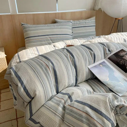 Cream bedding set with navy blue, caramel, and light grey multicolored stripes on soft cotton fabric