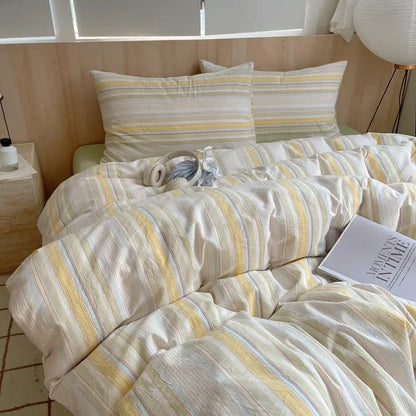Cream bedding set with warm yellow, grey and pastel blue stripes on soft cotton duvet and pillows